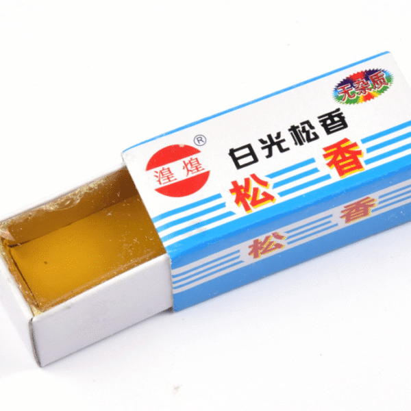 Каніфол у відкритій коробці, на якому зображено блок бурштинової смоли, що використовується для обслуговування та паяння скрипки.